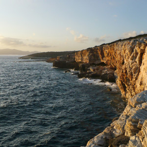 Cliffs off Trypiti beach at sunset time